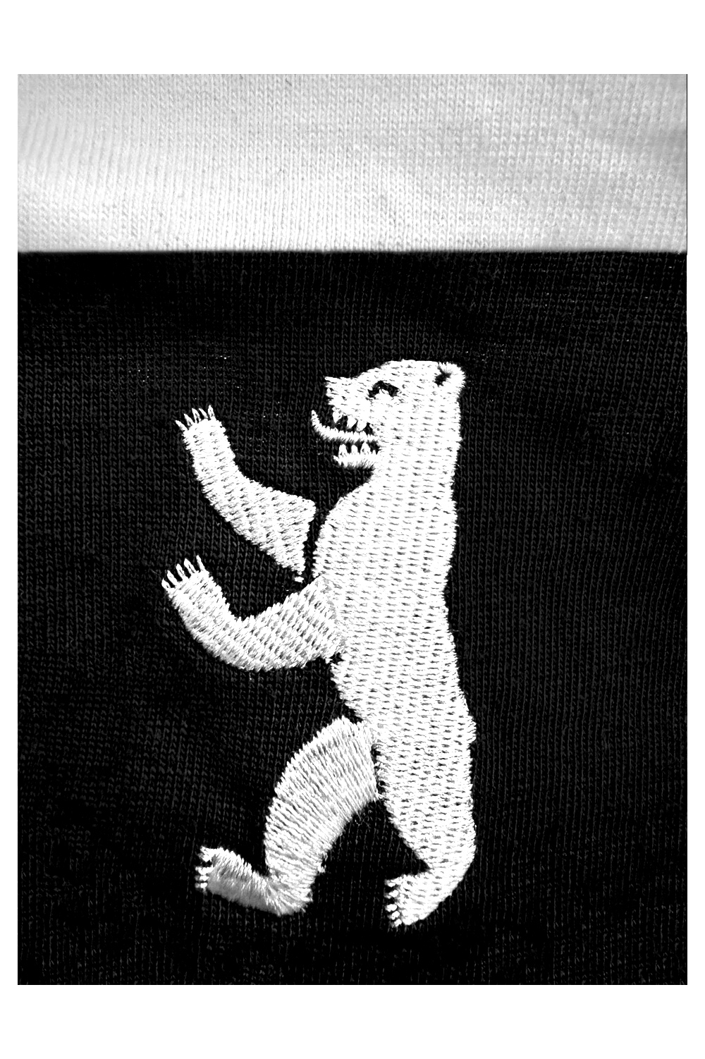 Close-up of the silver organic tribal embroidery on the David William KBERG jersey, showing the high-quality stitch detail and metallic texture.