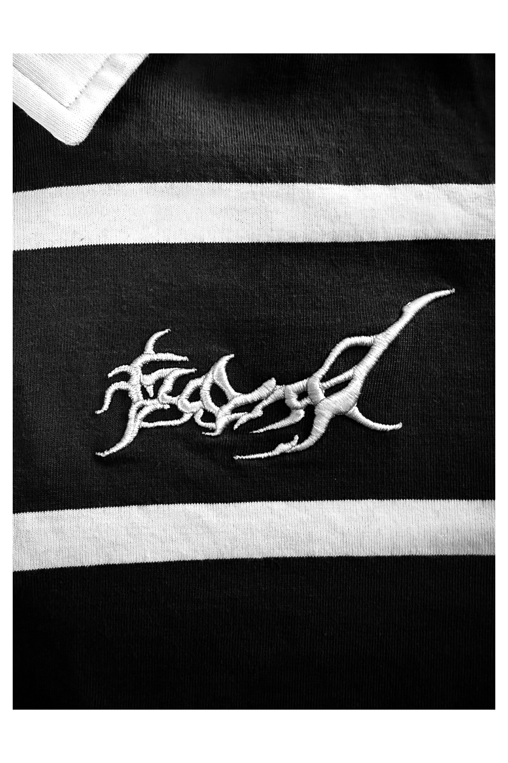 Close-up of the silver organic tribal embroidery on the David William KBERG jersey, showing the high-quality stitch detail and metallic texture.